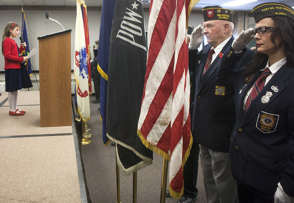Photo by Rashah McChesney/Peninsula Clarion  Sophie Micciche sings the national anthem during a Veterans Day ceremony on Wednesday Nov. 11, 2015 in Soldotna, Alaska.