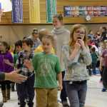 Photo by Megan Pacer/Peninsula Clarion Daniel Carter, a fourth-grade student, reaches out to high-five a veteran at the close of a Veterans Day assembly on Wednesday, Nov. 11, 2015 at Nikiski North Star Elementary School in Nikiski, Alaska. It was the school's first Veterans Day event.