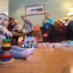 Photo by Kelly Sullivan/ Peninsula Clarion Nora Arness plays with toys while her mother Julie Arness chats with Kara Abel Thursday, Nov. 12, 2015, at Katy Bethune's home in Nikiski, Alaska. The three residents are hoping to start a parent's cooperative preschool in the community.