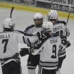 Photos by Joey Klecka/Peninsula Clarion Calvin HIlls, Jace Urban and Ethan Brown (facing forward) congratulate Cameron Knowlton on his first-period goal against Juneau-Douglas Thursday at the Soldotna Regional Sports Complex.
