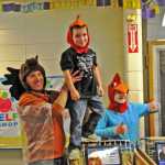 Photo by Elizabeth Earl/The Peninsula Clarion Borough Mayor Mike Navarre holds up Redoubt Elementary School kindergartener Dawson Harpole after their team won the annual Great Grocery Grab race on Friday.