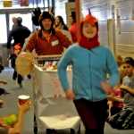 Photo by Elizabeth Earl/The Peninsula Clarion Laney Wattam, a sixth-grader at Redoubt Elementary School, leads borough mayor Mike Navarre down the hallway Friday during the Great Grocery Grab, an annual food drive event hosted by the school.