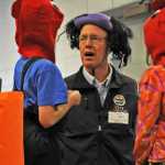 Photo by Elizabeth Earl/The Peninsula Clarion Former Redoubt Elementary School principal John Pothast talks strategy with his teammates Zach Buckbee (left) and Brynn Haglund (right) Friday during the school's annual Great Grocery Grab food drive.