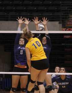 Photo by Joey Klecka/Peninsula Clarion Soldotna senior Lindsey Wong (8) and junior Judah Aley block a shot by Kodiak senior Richelle Walker (10) Friday at the Class 4A state volleyball tournament at the Alaska Airlines Arena in Anchorage.