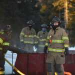Photo by Megan Pacer/Peninsula Clarion Engineer Jay Morrison, right, leads Central Emergency Services firefighters through an exercise called a changeover on Tuesday, Nov. 17, 2015 at the organization's station on Kalifornsky Beach Road. The team practiced switching from one water source to another with one of their engines in preperation for an upcoming engineering test.