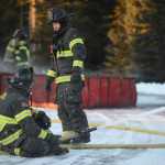 Photo by Megan Pacer/Peninsula Clarion Jason Cooper, left, and Dan Jensen, right, check in with each other during a practice drill on Tuesday, Nov. 17, 2015 at the Central Emergency Services station on Kalifornsky Beach Road. The firefighters have been training for about two months for an upcoming engineering test.