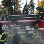 Photo by Megan Pacer/Peninsula Clarion Central Emergency Services Firefighter Jason Cooper aims a hose during practice drill on Tuesday, Nov. 17, 2015 at the department's station on Kalifornsky Beach Road. The firefighters have been training for about two months for an upcoming engineering test.