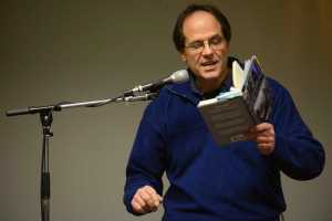 Photo by Megan Pacer/Peninsula Clarion Local writer Dave Atcheson reads excerpts from his books on his experiences sports and commercial fishing on Tuesday, Nov. 17, 2015 during a Trout Unlimited meeting at Odie's Deli in Soldotna, Alaska.