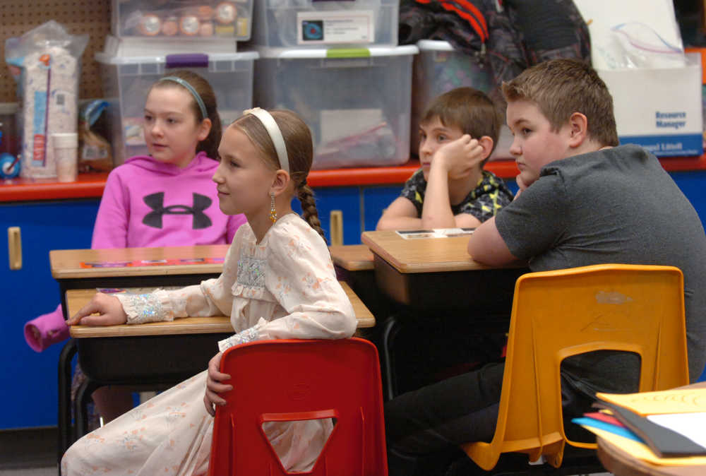 Photo by Megan Pacer/Peninsula Clarion From left to right: Zoya Fefelov, Lukia Chuprov, Lukah Kalugin, and Aquille Martushev listen to a presentation from Nouredine Mama, an exchange student from Cameroon, on Wednesday, Nov. 25, 2015 at Nikolaevsk School in Nikolaevsk, Alaska. Mama attends Homer High School and has been sharing his story at schools and churches in the area.