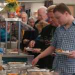 Photo by Megan Pacer/Peninsula Clarion Seniors and community members line up for a home-cooked meal on Thursday, Nov. 26, 2015 during a Thanksgiving Potluck at the Kenai Senior Citizens Center in Kenai, Alaska.