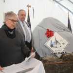 Photo by Megan Pacer/Peninsula Clarion Kenai Mayor Pat Porter, left, and former Kenai Mayor John Williams, right, present a boulder dedicated to members of Kenai's Charter Commission in a ceremony on Sunday, Nov. 29, 2015 outside City Hall in Kenai, Alaska. The commission members signed Kenai's charter in 1963, making it a home rule city.