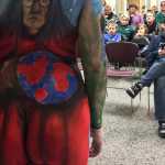 Photo by Rashah McChesney/Peninsula Clarion Angela Rene Roberts, the 2014 U.S. National Makeup Artist of the Year, works on a mural during a live body painting presentation on Wednesday Dec. 1, 2015 at Kenai Peninsula College - Kenai River Campus in Soldotna, Alaska. Roberts spent about two hours putting the finishing touches for a classroom of anatomy and physiology students - and curious members of the public. The piece took about four hours to complete.