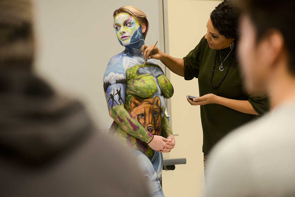 Photo by Rashah McChesney/Peninsula Clarion A king salmon swims over Sara Christensen's thigh during a live body painting presentation at Kenai Peninsula College - Kenai River Campus on Tuesday Dec. 1, 2015 in Soldotna, Alaska.