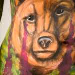 Photo by Rashah McChesney/Peninsula Clarion Members of the audience watch as body painter Angela Rene Roberts works on a mural on Sara Christensen during a live body painting demonstration on Tuesday Dec. 1, 2015 at Kenai Peninsula College's Kenai River Campus in Soldotna, Alaska.