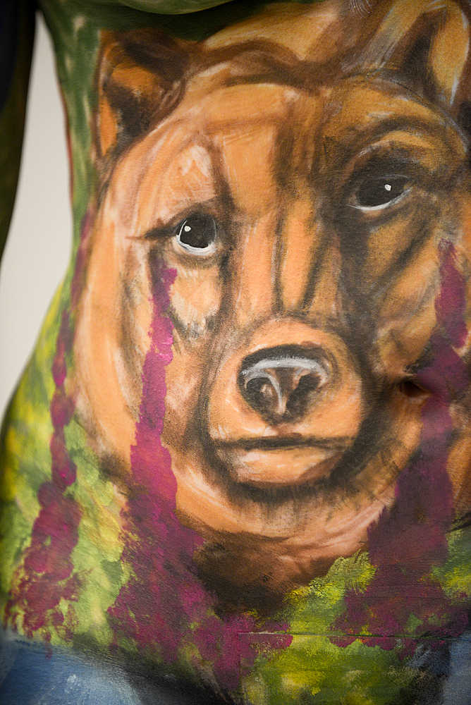 Photo by Rashah McChesney/Peninsula Clarion Members of the audience watch as body painter Angela Rene Roberts works on a mural on Sara Christensen during a live body painting demonstration on Tuesday Dec. 1, 2015 at Kenai Peninsula College's Kenai River Campus in Soldotna, Alaska.