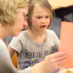 Photo by Kelly Sullivan/ Peninsula Clarion (Left) Danya Olson holds the building instructions up for her daughter, second grader Aeroh Olson, to read out loud Thursday, Dec. 3, 2015, at Mountain View Elementary School in Kenai, Alaska.