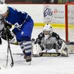Photo by Rashah McChesney/Peninsula Clarion Soldotna High School goalie Billy Yoder watches a tussle over the puck during a game against Palmer High School on Friday Dec. 4, 2015 in Soldotna, Alaska.