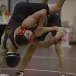 Photo by Joey Klecka/Peninsula Clarion Kenai Central's Jacob Anderson works over Grace Christian wrestler Todd Knell in the 132-pound bout of the seventh-place dual at the North-South Duals tournament Saturday at Soldotna Prep.