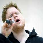 Photo by Rashah McChesney/Peninsula Clarion  Travis Gage, of Sterling, sings "You Raise Me Up," during a memorial for Jon Ployhar on Sunday Dec. 6, 2015 in Sterling, Alaska.