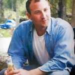 Photo by Rashah McChesney/Peninsula Clarion  Photos of Jon Ployhar decorated two tables in the Sterling Community Center where more than 100 gathered to remember the Sterling man who died during a confrontation with an Alaska State Trooper in October.