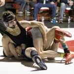 Soldotna High senior Seth Hutchison tries to roll Wasilla sophomore Isaiah Elvsaas during the 126-pound match of the championship finals of the Northern Lights Conference Championships Dec. 12 at Wasilla High School. Hutchison edged Elvsaas 5-4 in the match to win his fourth career region title.