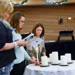 Photo by Megan Pacer/Peninsula Clarion From left to right: Gail Kennedy, Lisa Garcia and Brenda Zuck lead local families in the second annual Candlelight Remembrance Program on Sunday, Dec. 13, 2015 at the Christ Lutheran Church in Soldotna, Alaska. The local chapter of The Compassionate Friends hosts the event for parents whose children have died as part of a national movement.