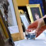 Photo by Megan Pacer/Peninsula Clarion Parents place lit candles in front of pictures of their dead children during the second annual Candlelight Remembrance Program on Sunday, Dec. 13, 2015 in Soldotna, Alaska. The local chapter of The Compassionate Friends host the vigil for parents dealing with the death of their children.