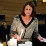 Photo by Megan Pacer/Peninsula Clarion Soldotna resident Brenda Zuck lights candles at the start of the second annual Candlelight Remembrance Program on Sunday, Dec. 13, 2015 at the Christ Lutheran Church in Soldotna, Alaska. Zuck, who lost a daughter in 2007, helped form the local chapter of The Compassionate Friends, which hosts the event for parents whose children have died.