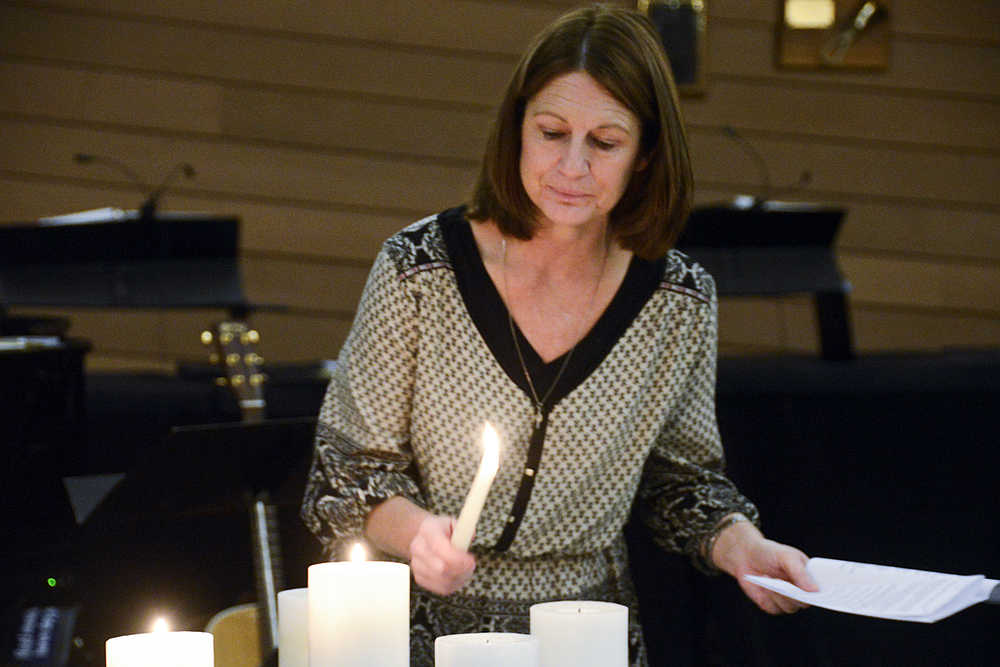 Photo by Megan Pacer/Peninsula Clarion Soldotna resident Brenda Zuck lights candles at the start of the second annual Candlelight Remembrance Program on Sunday, Dec. 13, 2015 at the Christ Lutheran Church in Soldotna, Alaska. Zuck, who lost a daughter in 2007, helped form the local chapter of The Compassionate Friends, which hosts the event for parents whose children have died.