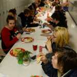 Photo by Megan Pacer/Peninsula Clarion Students and staff at Kenai Alternative High School enjoy the annual Grinch Day lunch on Thursday, Dec. 17, 2015 at the school in Kenai, Alaska. Students help set up the meal and cook some of the dishes before they are presented with gifts to send them off to their winter break.