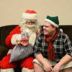 Photo by Megan Pacer/Peninsula Clarion Kenai Alternative High School senior Kody Vaught accepts a hand-made pillow case filled with treats from Hal Smalley, posing as Santa Clause, on Thursday, Dec. 17, 2015 during the school's annual Grinch Day in Kenai, Alaska.