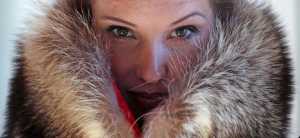 Pam Paquin poses with an "accidental fur" raccoon neck muff she created in Central Massachusetts, Wednesday, Nov. 18, 2015. Paquin's company, Petite Mort, uses roadkill fur harvested from animal carcasses culled with the help of highway departments and animal control officers. (AP Photo/Charles Krupa)