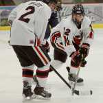 Photo by Rashah McChesney/Peninsula Clarion Kenai's Tristan Bulot and Bailey Maxson work for control of the puck during a game against the Homer Mariners on Thursday Dec. 17, 2015 in Soldotna, Alaska.