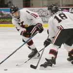 Photo by Rashah McChesney/Peninsula Clarion Kenai's Stefan Gelosa and Jakeb Obrien fight for control of the puck during a game against the Homer Mariners on Thursday Dec. 17, 2015 in Soldotna, Alaska.