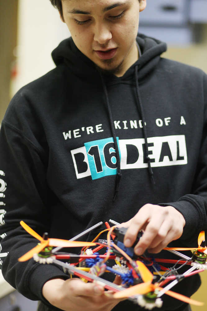 Photo by Kelly Sullivan/ Peninsula Clarion Senior Corin Cooper explains some of his first experiences flying drones Wednesday, Dec. 9, 2015, at Nikiski Middle-High School in Nikiski, Alaska.
