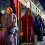 Ben Boettger/Peninsula Clarion Candle merchants Lucas and Jessica Loggins stand in a row of simulated market booths in the College Hieghts Baptist Church recreation of Biblical Bethlehem on Friday, Dec. 18 in Soldotna. The church's Bethlehem Revisited exhibit will be open nightly until Dec. 21.