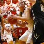 Ben Boettger/Peninsula Clarion Kenai basketball player Abby Beck eyes the basket through the arms of South Anchorage's Isabelle Lada (right), as Marina Olson closes behind her during a game on Friday, Dec. 18 at Kenai Central High School.