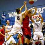 Ben Boettger/Peninsula Clarion Soldotna basketball player Griffen Caset leaps for the basket over Houston High School's Ben Bitler, as Soldotna's Adrian Gomer-Dickson stands ready for rebound during a game on Friday, Dec. 18 at Soldotna High School.