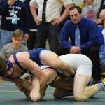 Soldotna senior Seth Hutchison works over Lathrop sophomore Westley Bockert in the 126-pound final at the Class 4A state wrestling championships at Bartlett High. Hutchison pinned Bockert to become just the ninth wrestler in Alaska history to win four straight state titles.