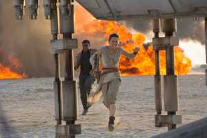 This photo provided by Disney/Lucasfilm shows Daisy Ridley, right, as Rey, and John Boyega as Finn, in a scene from the film, "Star Wars: The Force Awakens," directed by J.J. Abrams. The movie opens in U.S. theaters on Friday, Dec. 18, 2015. (David James/Disney/Lucasfilm via AP)