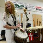 Photo by Megan Pacer/Peninsula Clarion Sterling resident Sabrina Hensley examines a doll that was passed through a small crowd during a concert on Sunday, Dec. 20, 2015 at the Sterling Community Center in Sterling, Alaska. The concert featured songs from "Holy Ground," a new CD by White Eagle Medicine Woman.