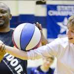 Photo by Rashah McChesney/Peninsula Clarion Les "Pee-Wee" Harrison, founder of the Portland-based Showtime Athletics and former Harlem All-Star, walks Kai Mckibben, 14, through a trick during a presentation for a group from the Kenai Peninsula Youth Court on Monday Dec. 21, 2015 in Soldotna, Alaska.