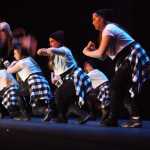 Photo by Kelly Sullivan/ Peninsula Clarion  In this May 23, 2015 file photo Kendyl Cannava and Telotha Braden bow their heads while Vergine Hedberg says a prayer for everyone before their performances in the Vergine's Dance Studio Annual Recital at Kenai Central High School in Kenai, Alaska. Hedberg said praying helps her feel secure that things will go well for each dancer during their performances.