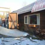 Photo by Megan Pacer/Peninsula Clarion The strips of metal roofing cover the gound on Thursday, Dec. 31, 2015 outside Porterhouse Grill in Sterling, Alaska, after a wind storm stripped a large section of the roof off and caused water damage inside.