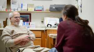 Photo by Rashah McChesney/Peninsula Clarion Dr. Michael Merrick talks to a patient about her addiction as she comes in to get her perscription to Suboxone, a medicine used to treat opioid addictions, on Dec. 23, 2015 in Merrick's office in Kenai, Alaska. Kenai Peninsula doctors wrangle with access and treatment for opoid addicts.