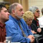 Photo by Rashah McChesney/Peninsula Clarion Kenai City Manager Rick Koch listens to Sen. Peter Micche, R-Soldotna, on Tuesday Jan. 5, 2015 during a Chamber of Commerce luncheon at the Soldotna Sports Complex in Soldotna, Alaska.
