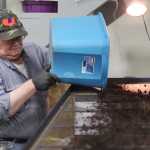 Photo by Kelly Sullivan/ Peninsula Clarion Fred Sturman turns a bucket of worms Wednesday, Dec. 30, 2015, at Circle M Worm Farm of Alaska in Nikiski, Alaska.