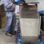 Photo by Kelly Sullivan/ Peninsula Clarion Fred Sturman turns a bucket of worms Wednesday, Dec. 30, 2015, at Circle M Worm Farm of Alaska in Nikiski, Alaska.