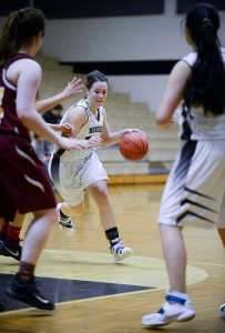Photo by Rashah McChesney/Peninsula Clarion Nikiski's Hallie Riddall dodges around a Mt. Edgecumbe player during their game on Saturday Jan. 9, 2015 in Nikiski, Alaska. Nikiski lost the game 63-24.