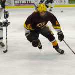 Ben Boettger/Peninsula Clarion Soldotna High School hockey player Emily Werner (left) chases down Dimond High School's Cody Dearing during a game on Friday, Jan. 9 at the Soldotna Regional Sports complex.